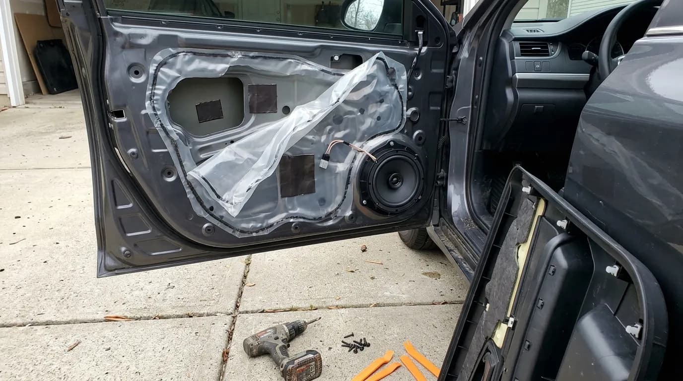 Car door opened up during a speaker install, with sound deadening applied